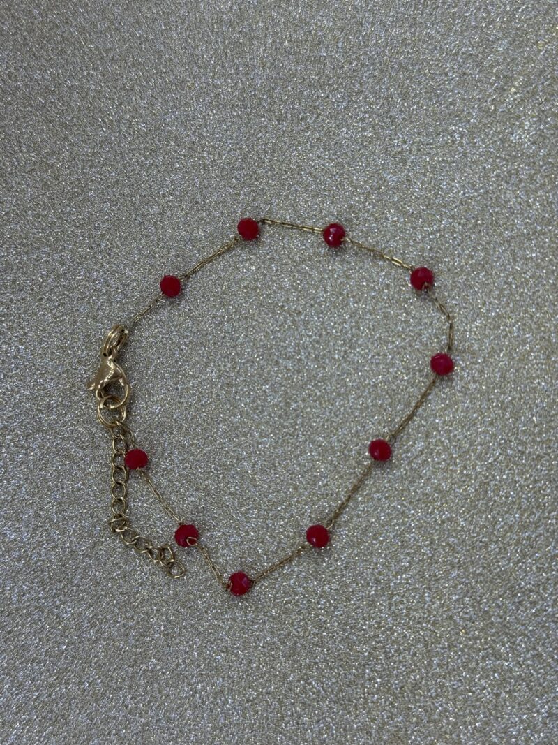 Gold bracelet with red stones